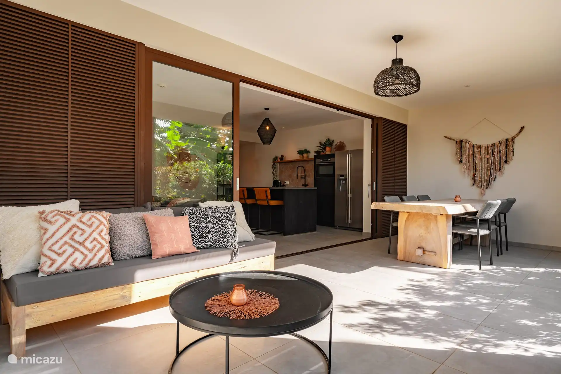 The outdoor terrace with large dining table and lounge set.