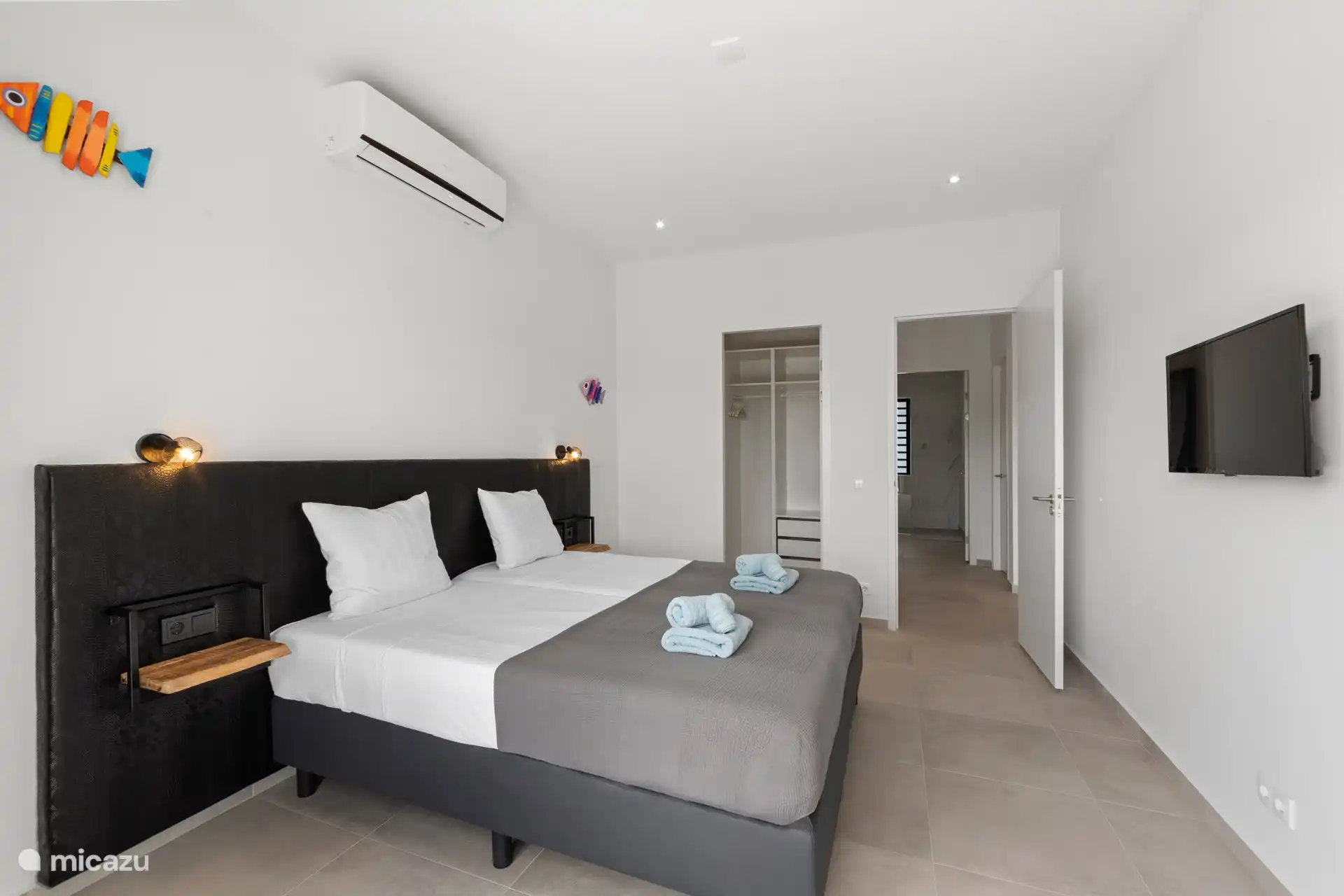 Master bedroom with large walk-in closet, TV and ensuite bathroom