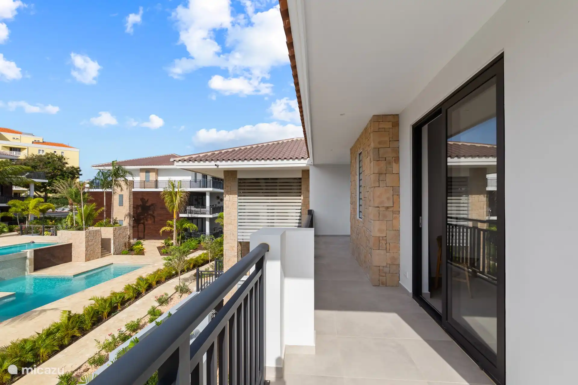 Through bedrooms 2 and 3 you have access to the balcony at the back with a view of one of the swimming pools.