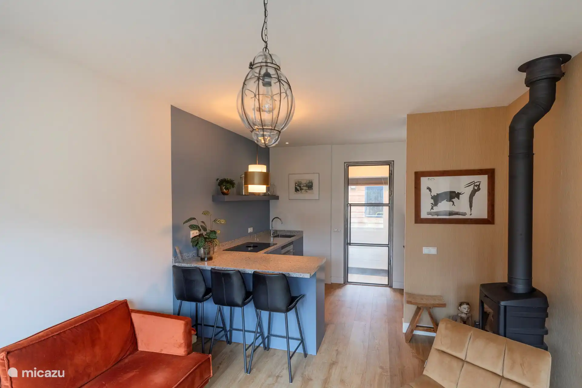 Der Flur und die offene Küche sind durch eine Glastür voneinander getrennt.