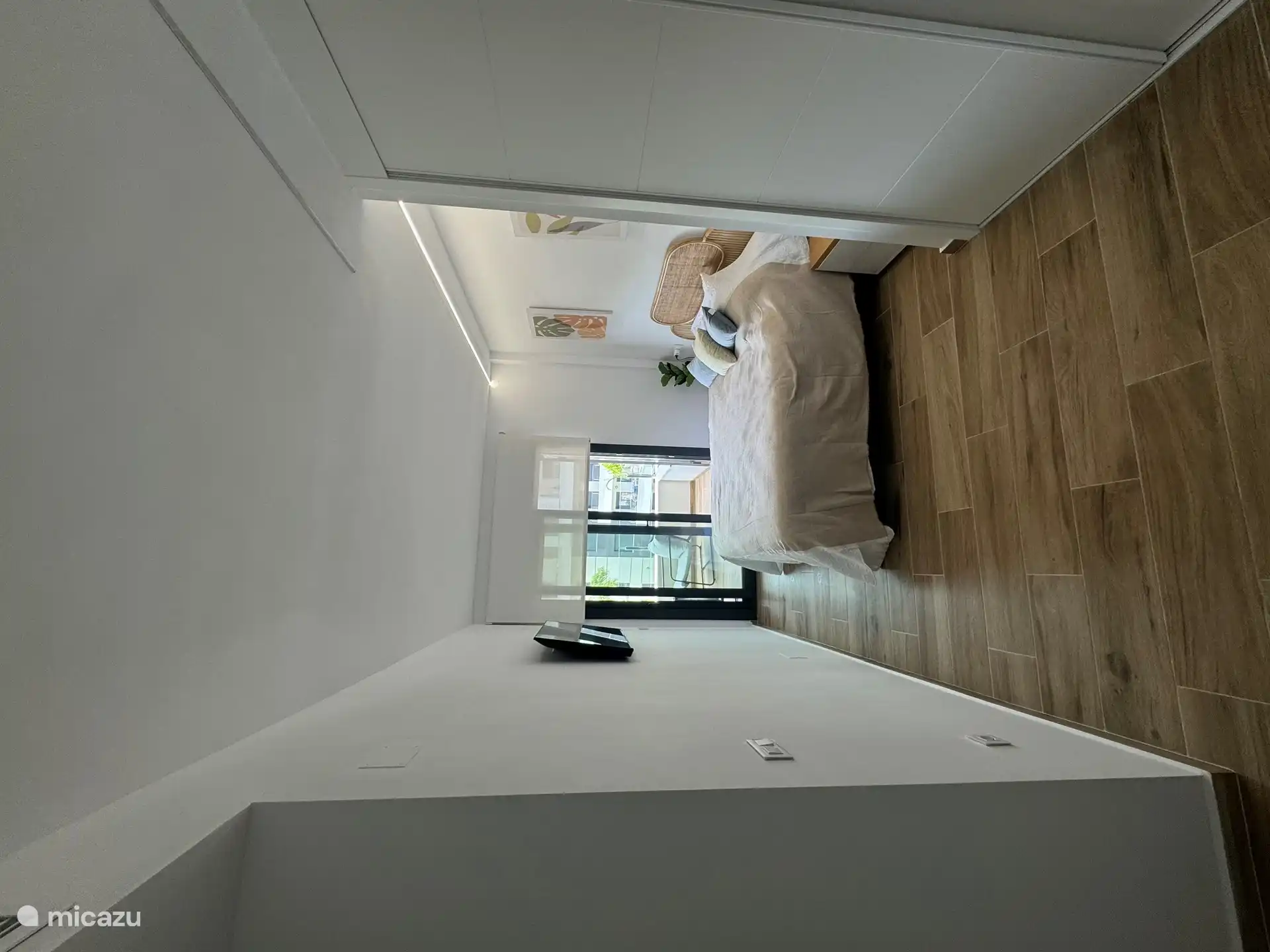 Slaapkamer 2 met TV en schuifpui naar het balkon