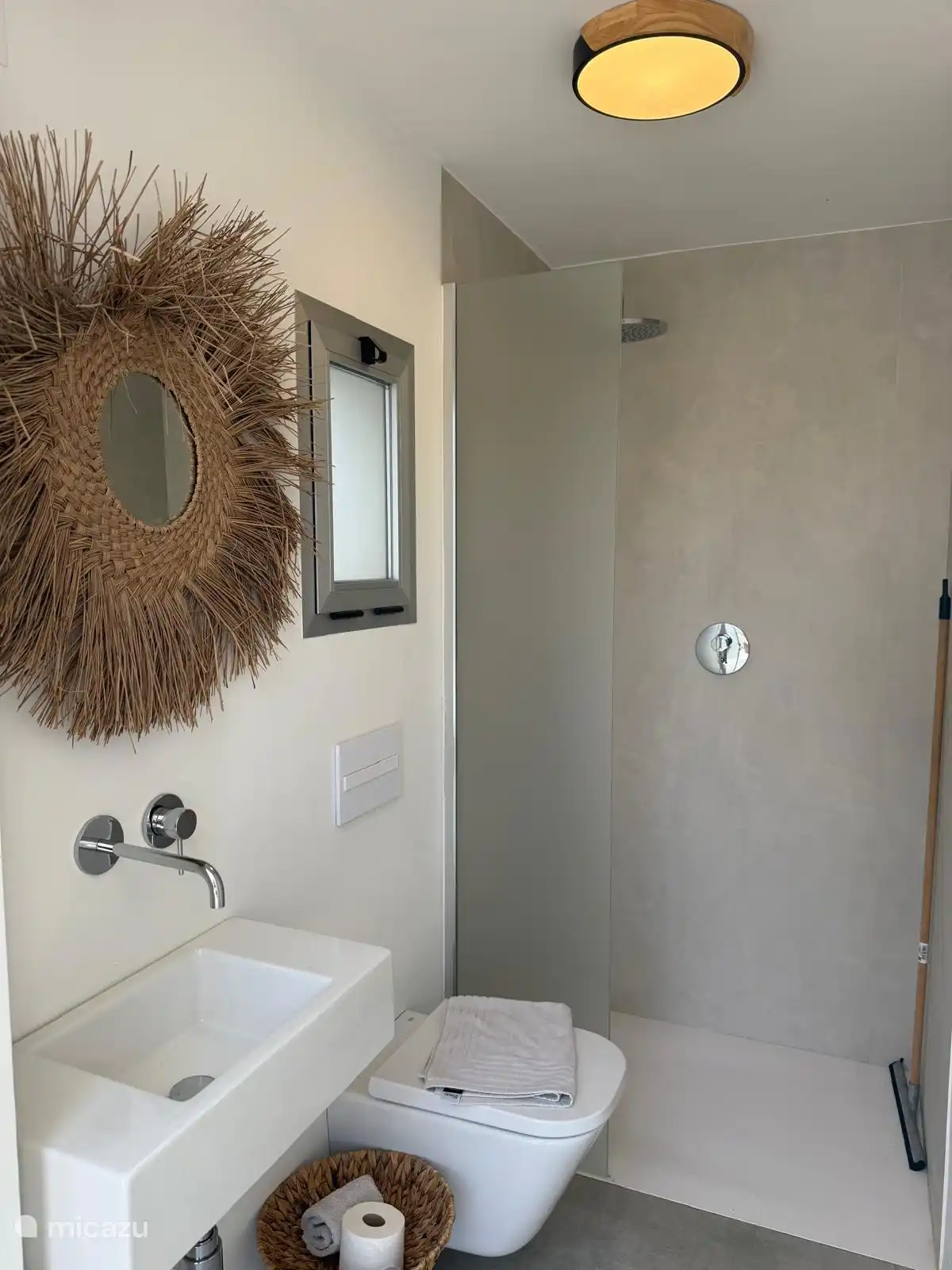 the bathroom with shower and toilet by the pool