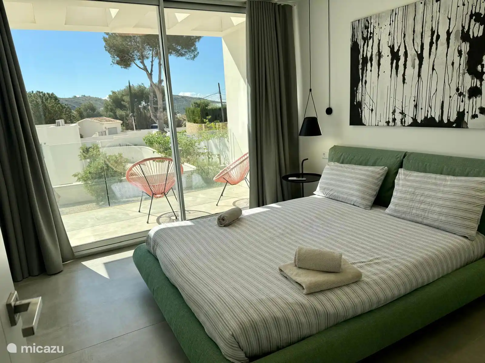 the master bedroom with ensuite bathroom, air conditioning and balcony