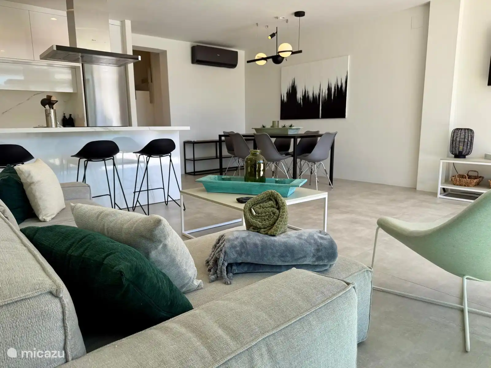 The living room with kitchen and dining area is adjacent to the sun terrace and swimming pool