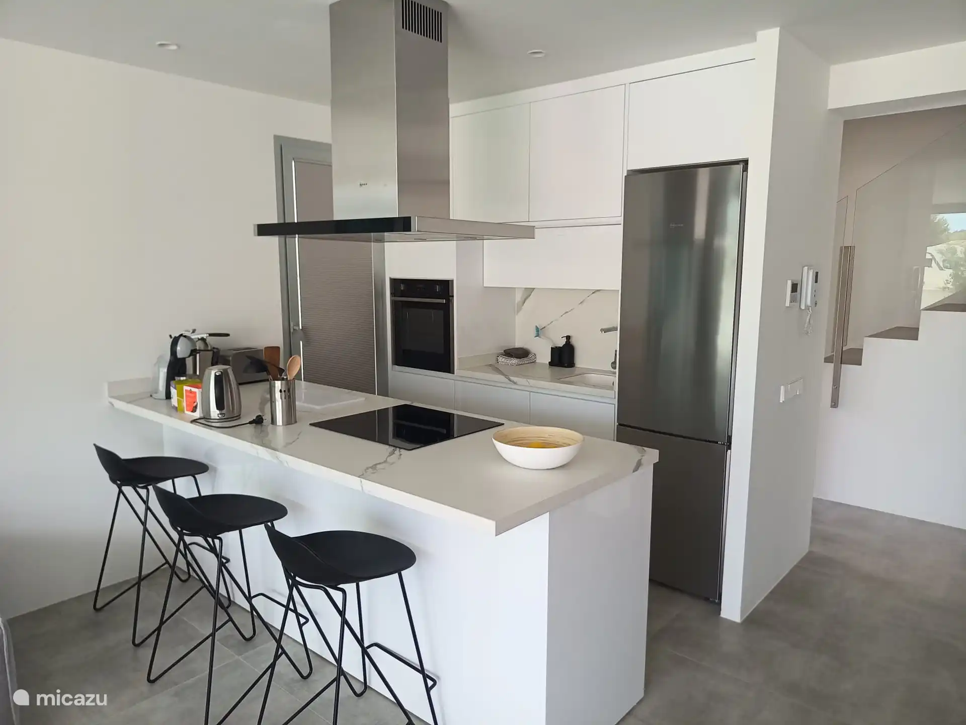 the kitchen is equipped with a dishwasher, fridge with freezer drawers, Dolce gusto machine, oven, kettle, toaster and an orange press