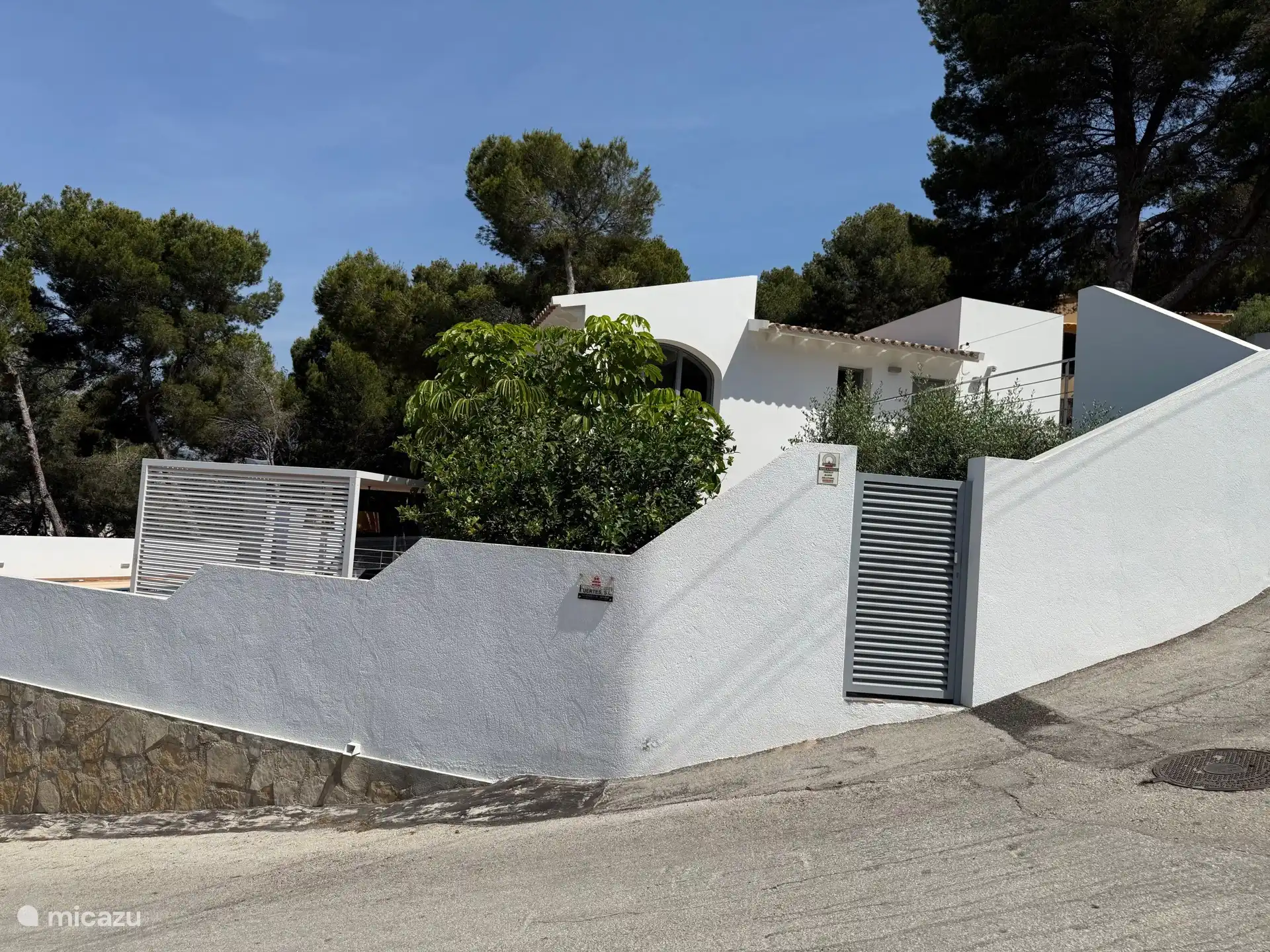 The modern villa is located on a large fenced plot