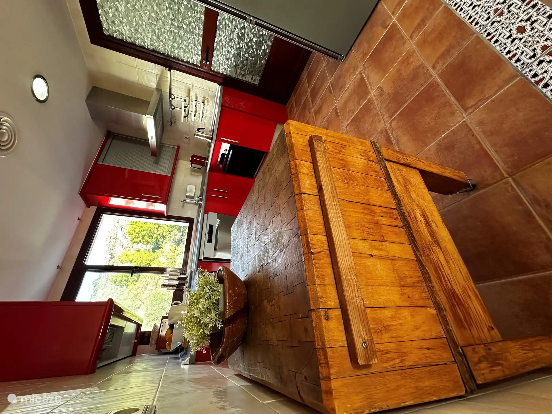 The kitchen with adjoining utility room, where the washing machine is located.