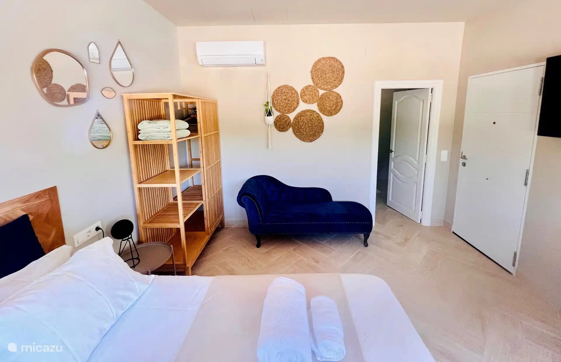 Foto general que muestra la puerta del baño y la puerta principal de la terraza privada con la cocina exterior totalmente equipada.