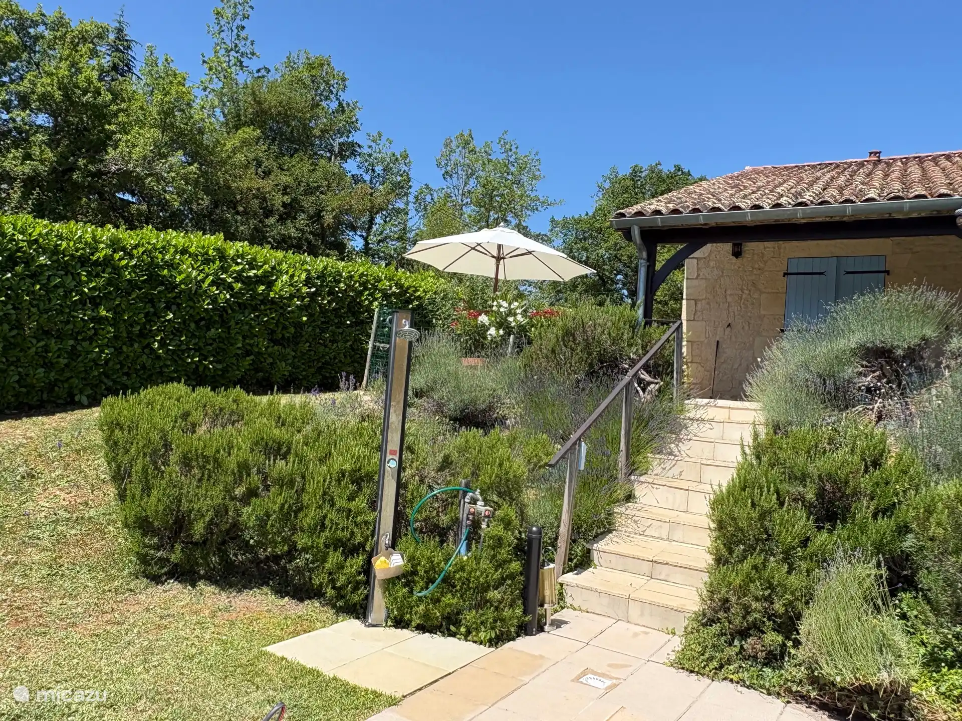 Outdoor shower next to swimming pool 