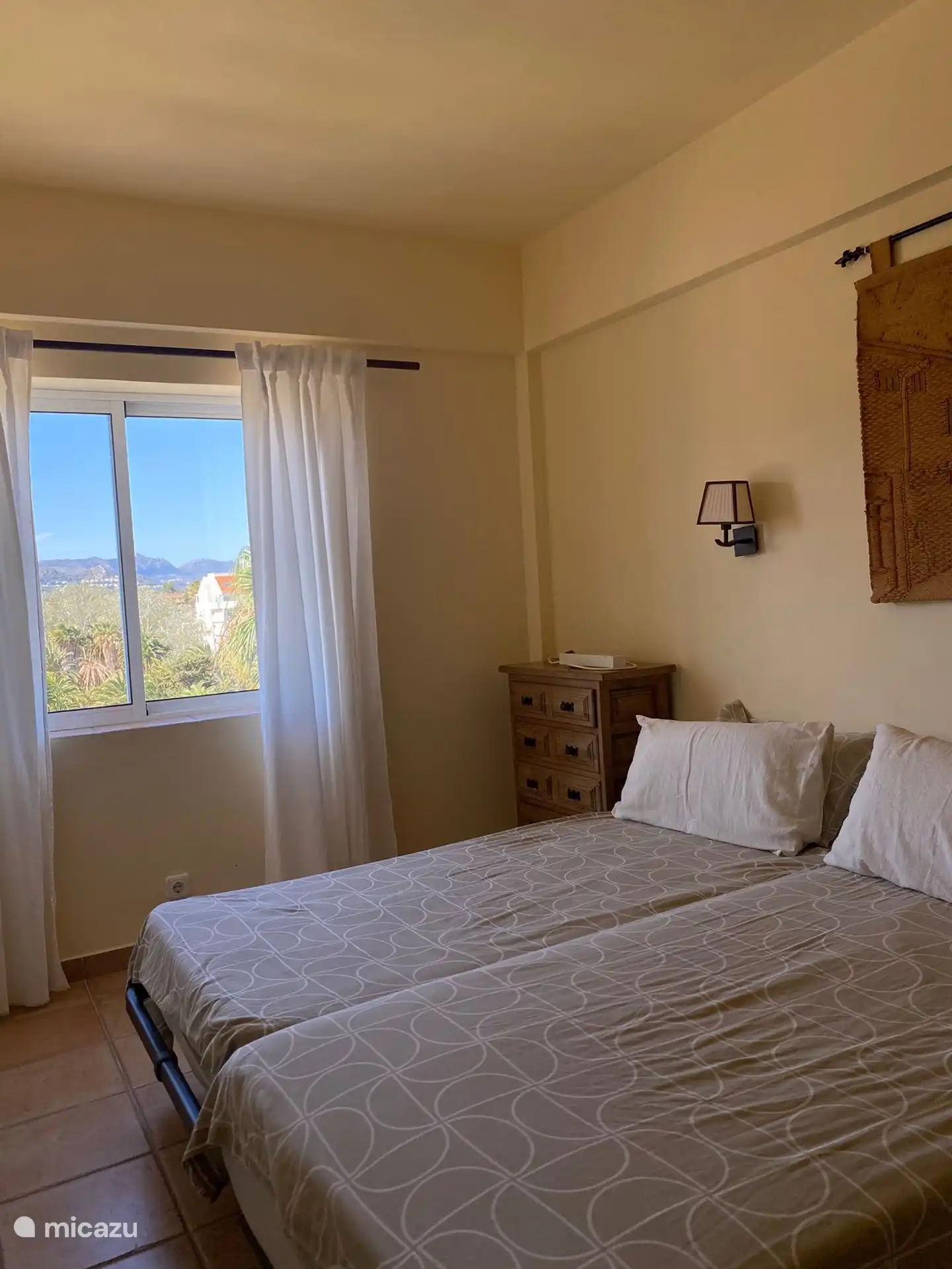 Second bedroom with two single beds, offers views towards the Mountains.