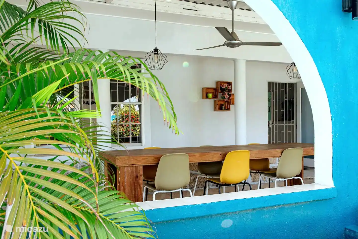 Cozy covered porch with spacious dining table.