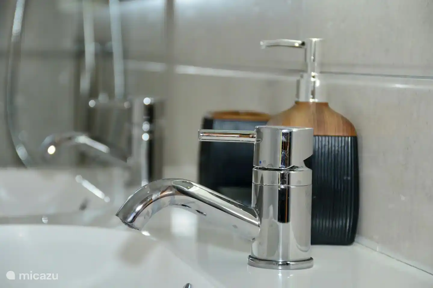 The spacious and modern master bathroom has an extra mirror, hair dryer, first aid kit and shower with hot water.