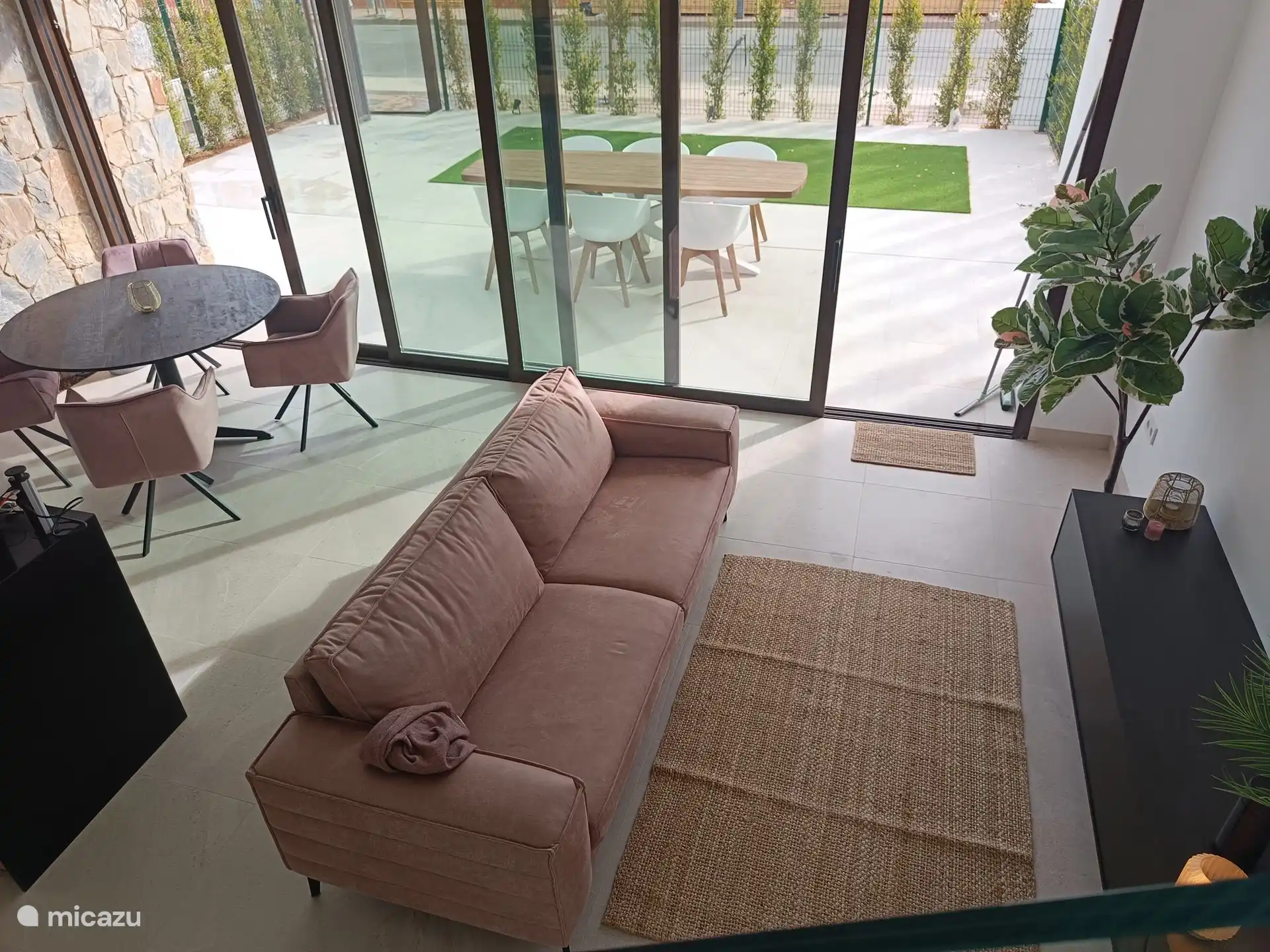 Ground floor with living room with open kitchen with adjoining terrace. Terrace has an automatic sun awning.