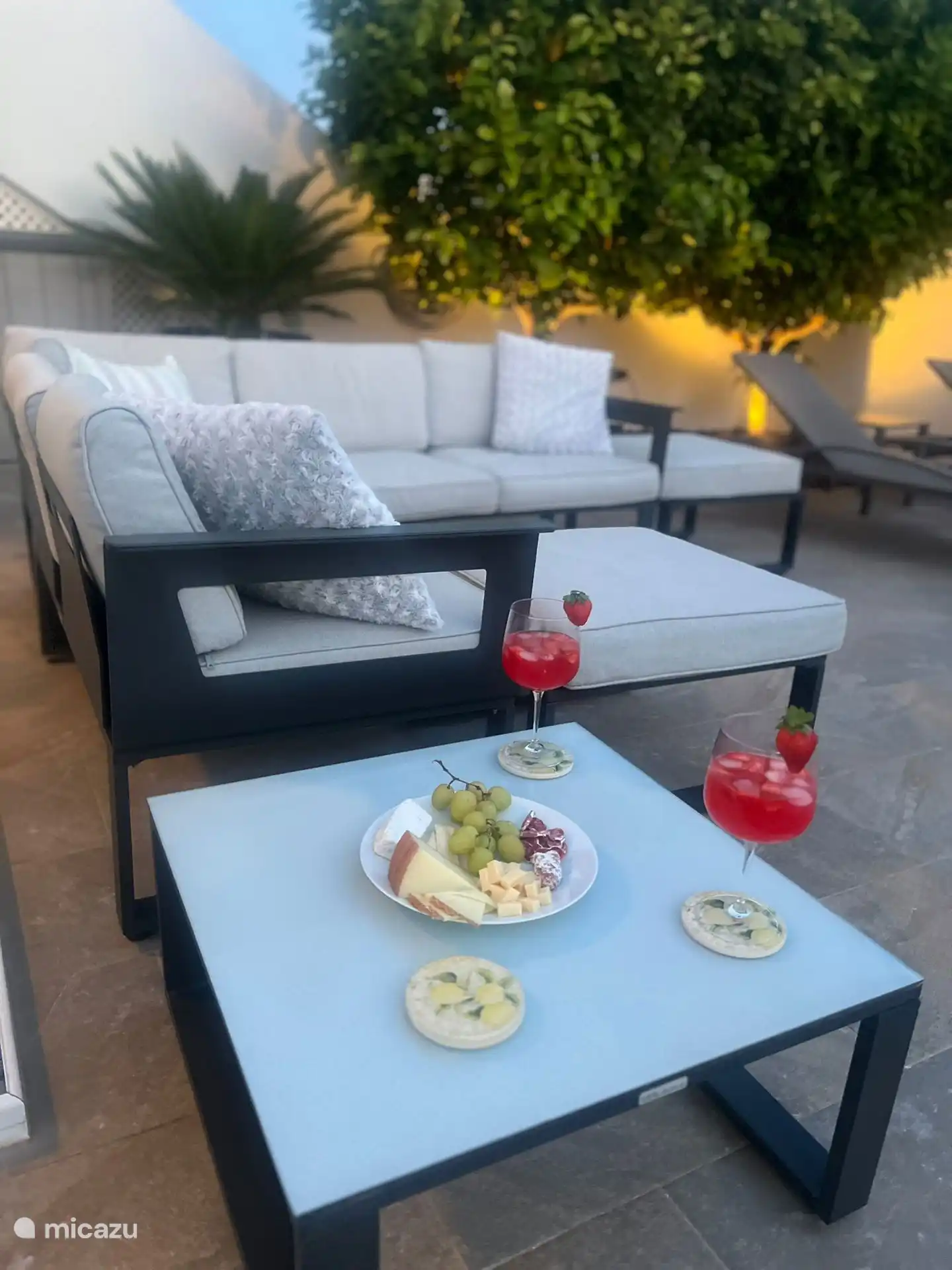 Terrace with lounge set and two sun loungers