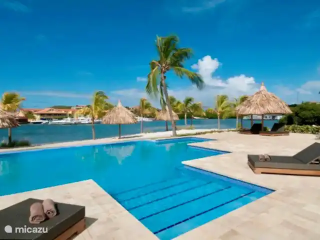 Location de Vacances Curaçao, Banda Ariba (est), Spaanse Water, appartement - Penthouse de luxe Casa Bon Vie Piscine à débordement directement sur la plage privée avec transats et chaises.