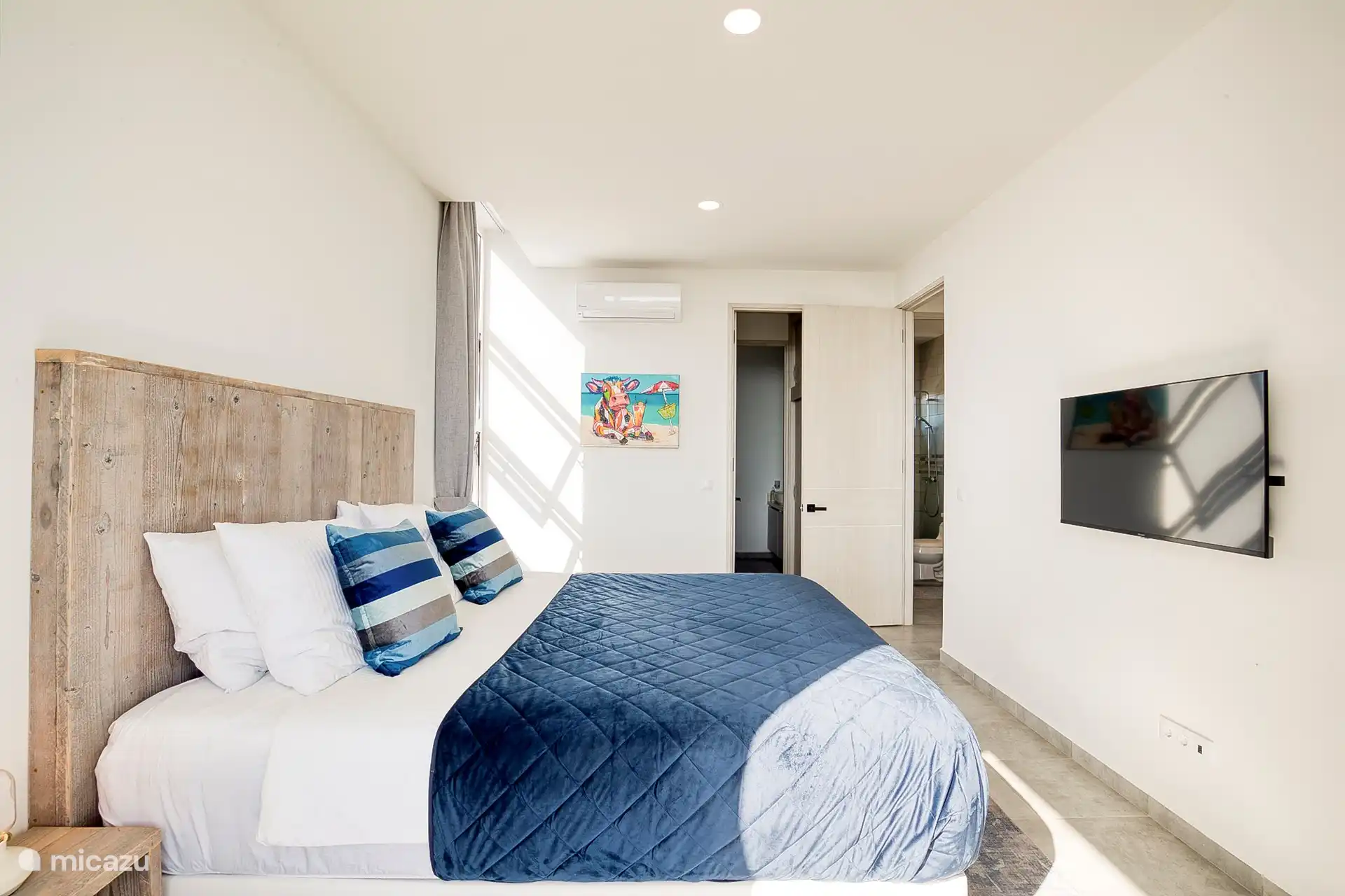 Master bedroom with comfortable king-size box spring bed, walk-in closet and en-suite bathroom