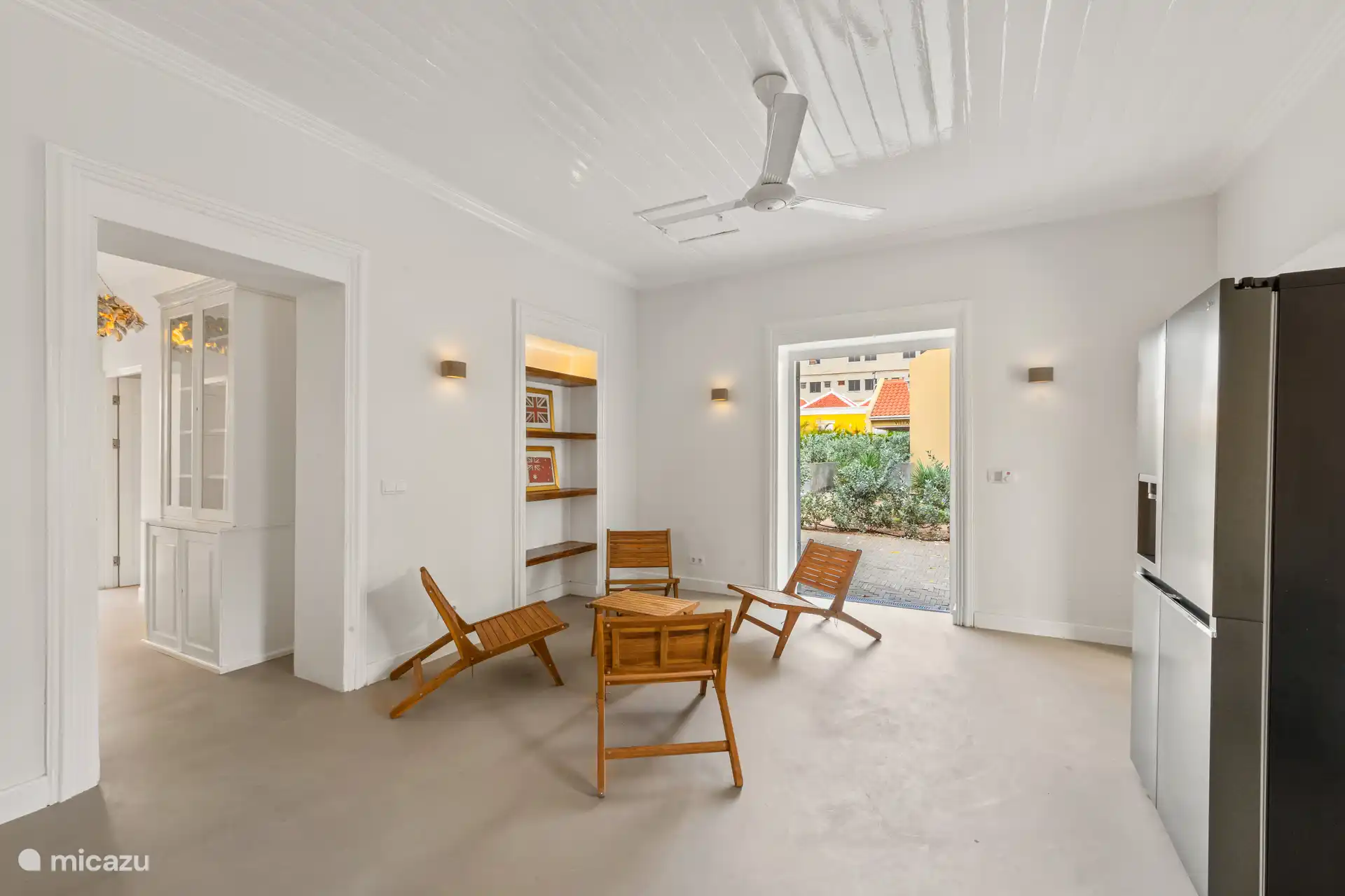 Bright kitchen with modern worktop, stylish sitting area and patio doors to the side terrace