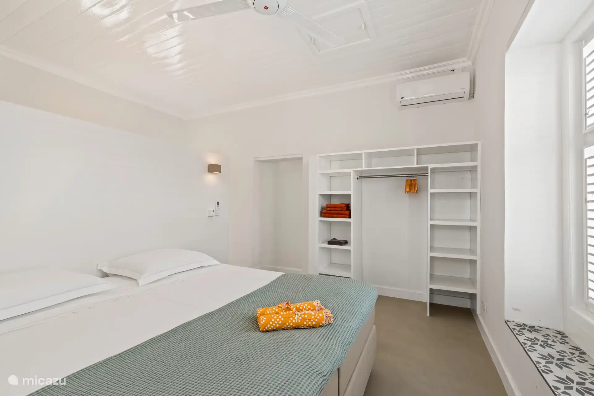 Spacious bedroom with air conditioning, built-in wardrobe and made beds of Egyptian cotton