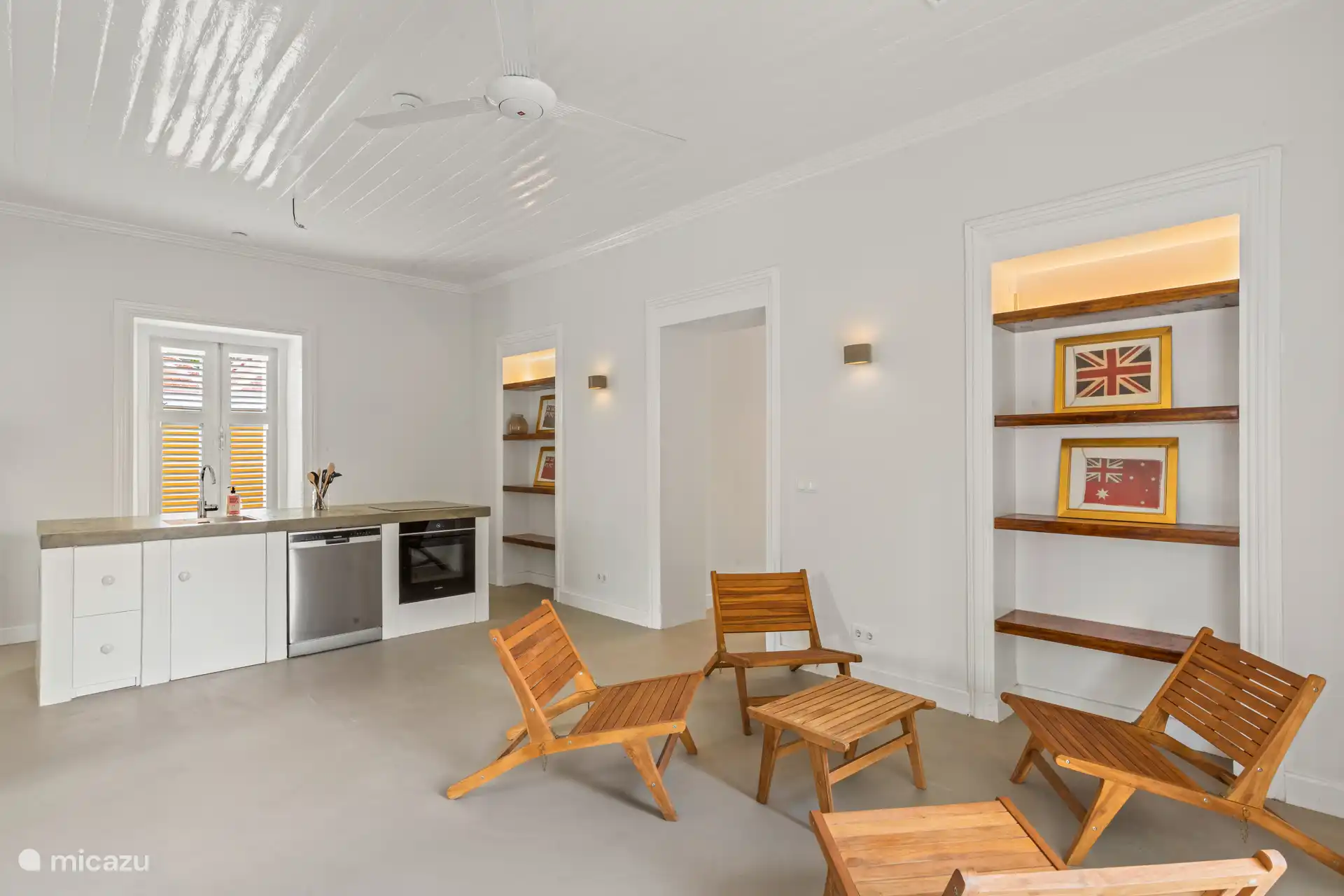 Bright kitchen with modern worktop, stylish sitting area and open connection to the attractive patio