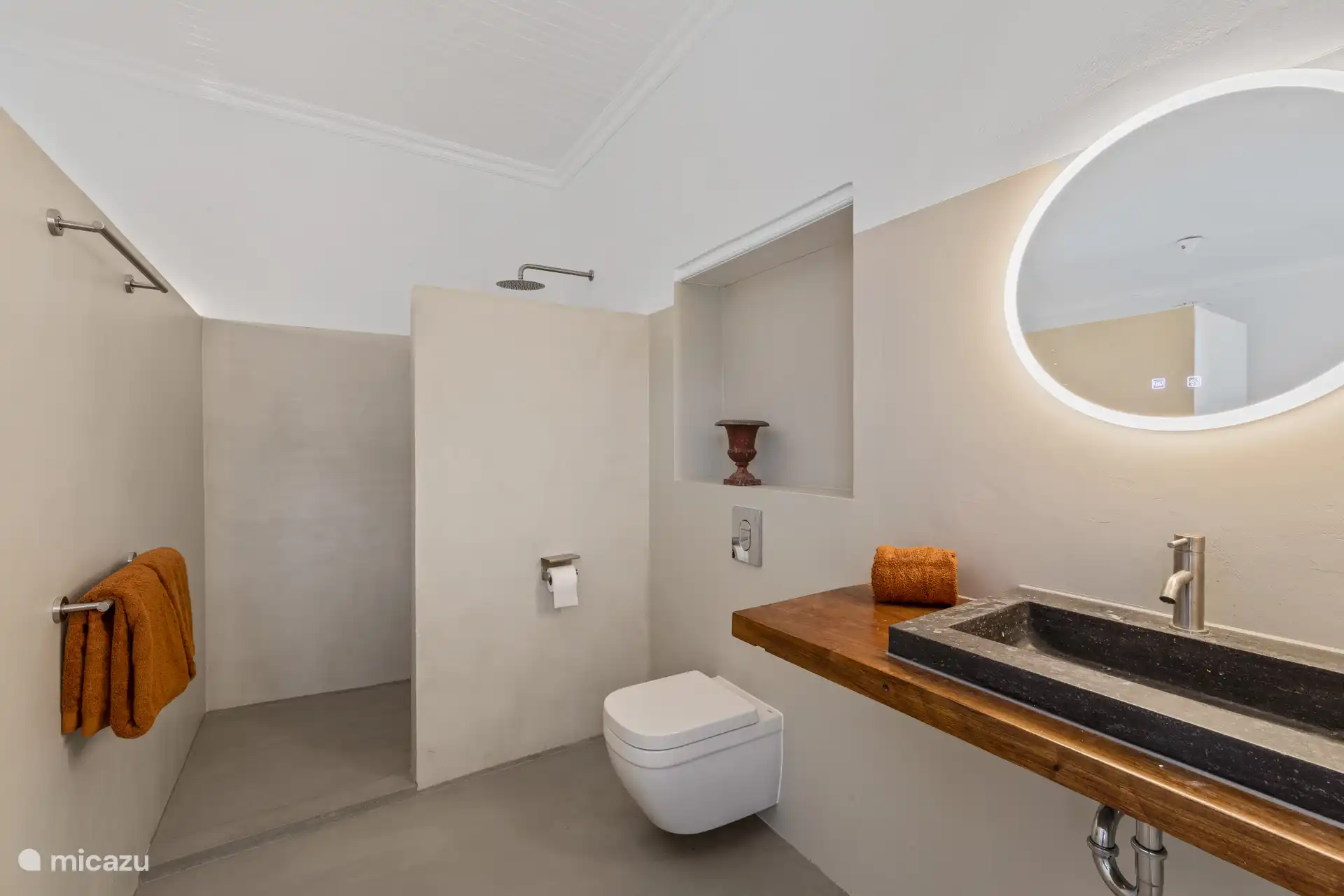Minimalist designed bathroom with rain shower, natural stone sink and luxurious details for a serene and stylish experience