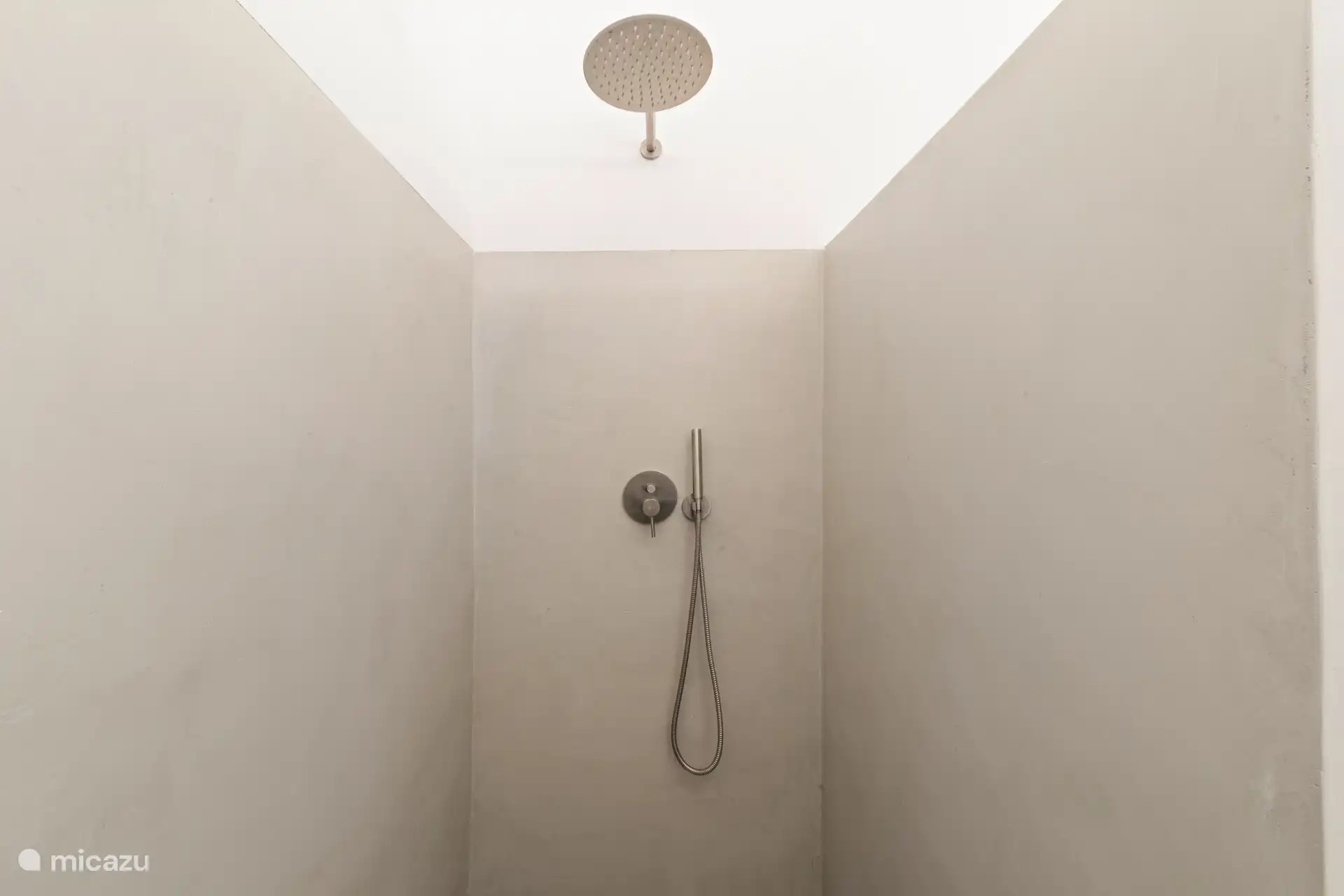 Minimalist walk-in shower with spacious rain shower and sleek finish