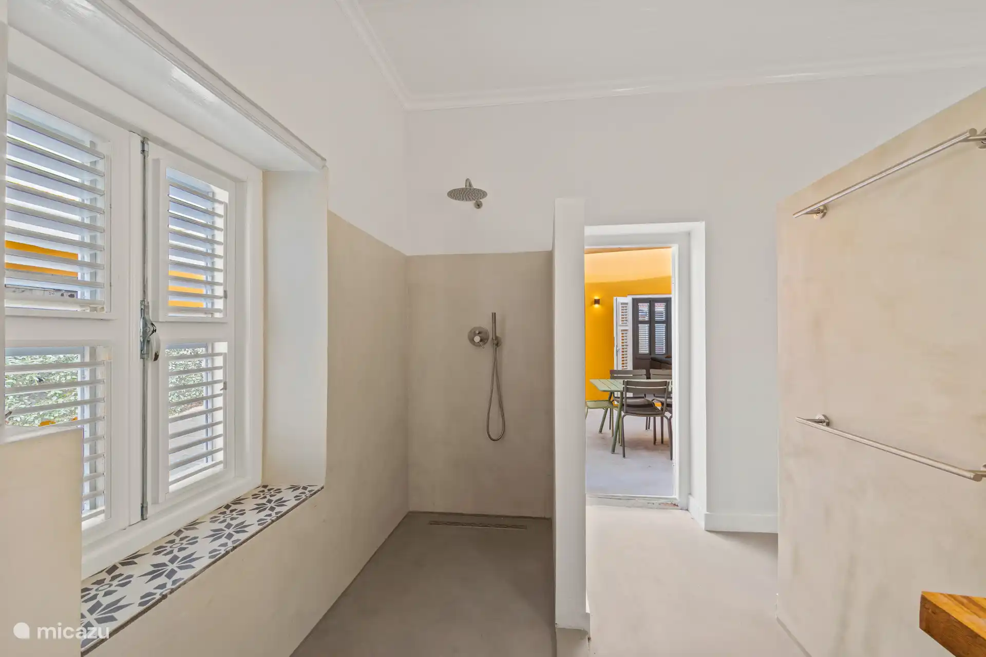 Contemporary rain shower in the former kitchen, overlooking the patio and preserving the historic atmosphere