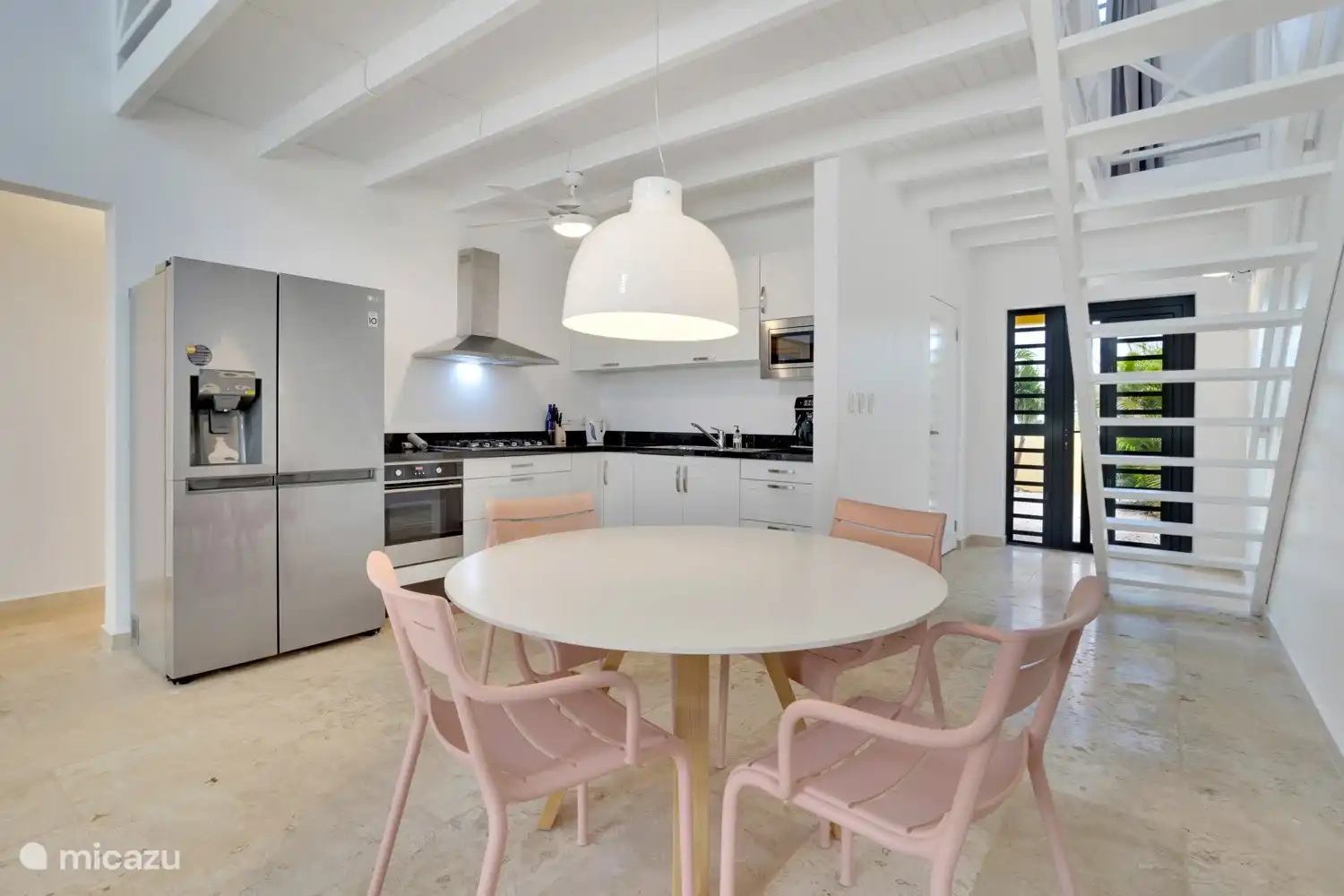 L-shaped open kitchen that is equipped with high-quality European appliances. 