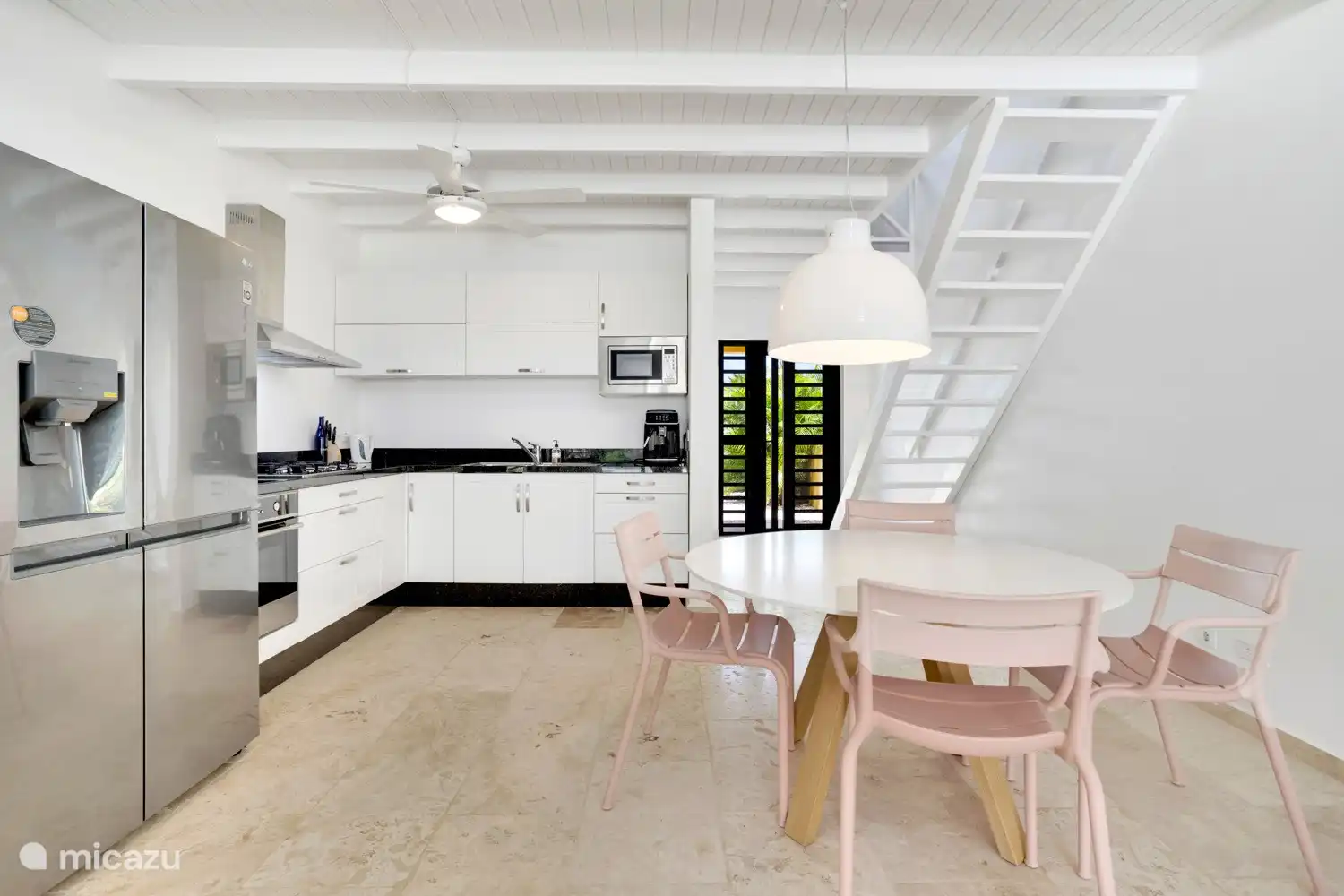 L-shaped open kitchen that is equipped with high-quality European appliances. 