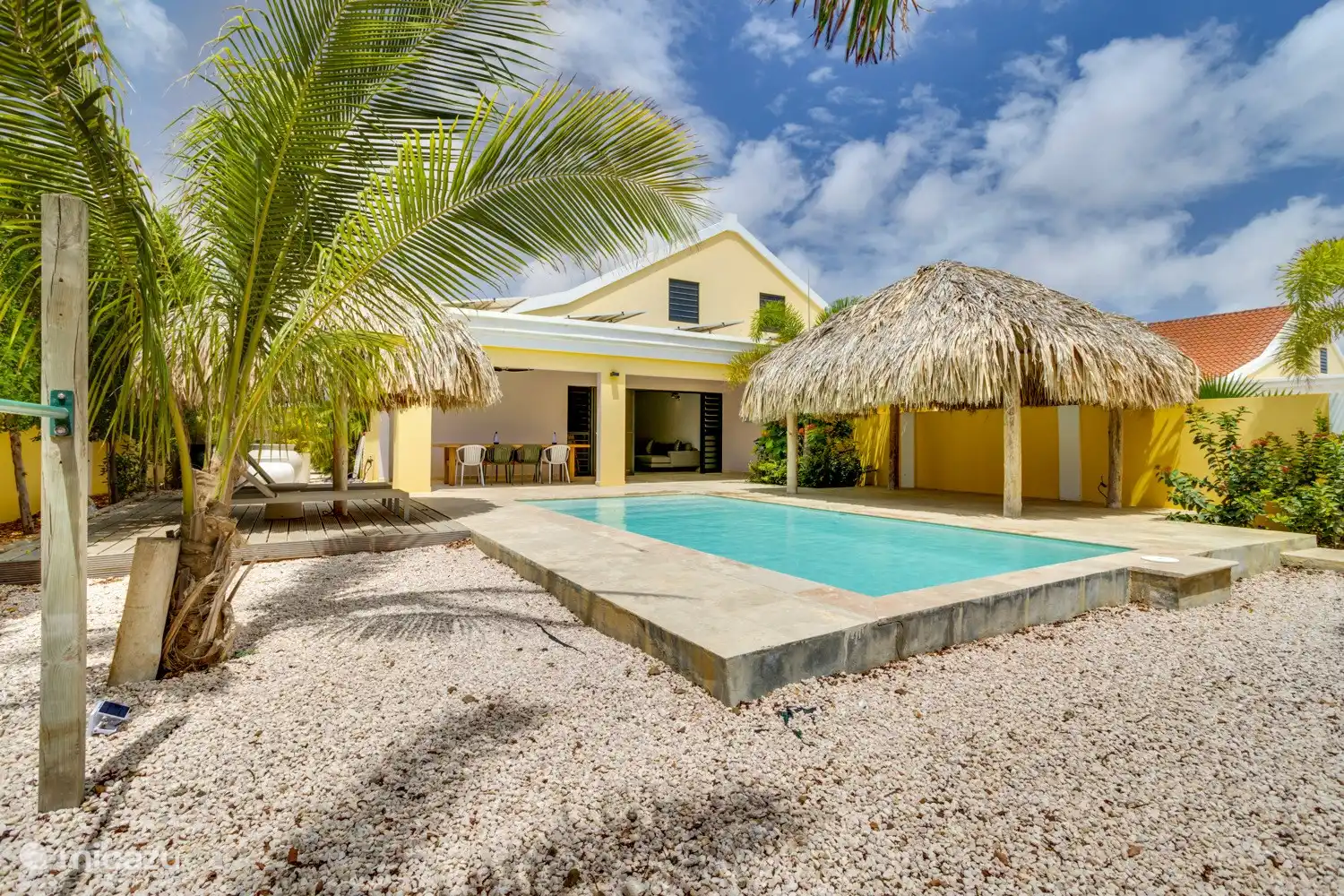 The large terrace, complete with sunbeds, outdoor seating areas and two palapas, surrounds a beautiful saltwater pool.