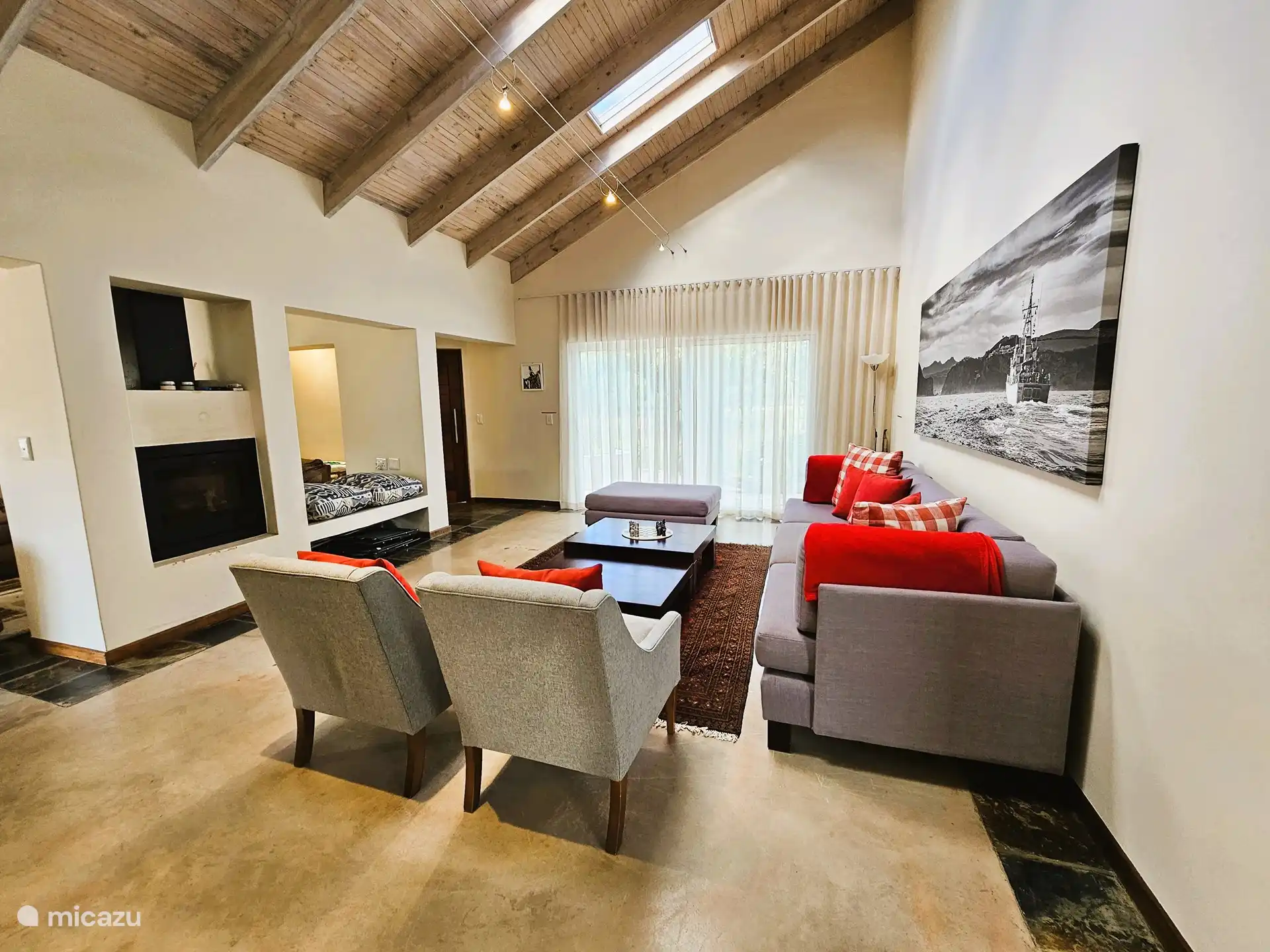 Open plan on the ground floor. Two different lounges with sofas, opens to the outdoor pool and entertainment area.