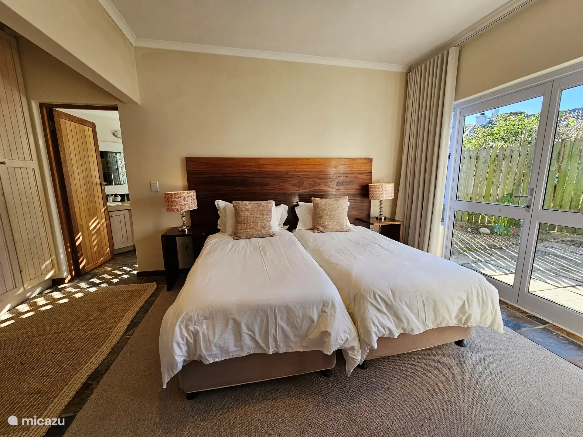 Second bedroom, ground floor, with en suite full bathroom. This bedroom has French doors to the side terrace. Beds can, on request, be made up as a king size bed.