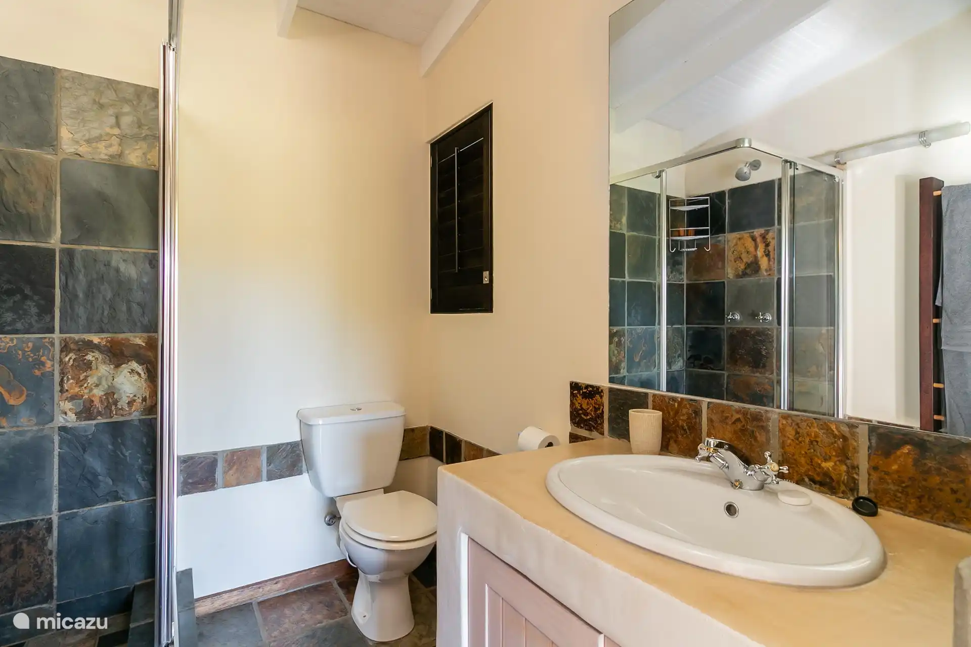 Bathroom with sink, shower cabin and toilet ensuite to the third bedroom. 
