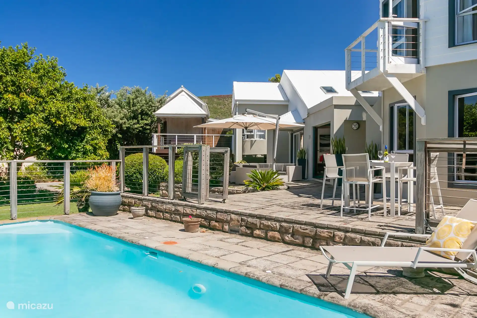 Overview sits sharing by the pool