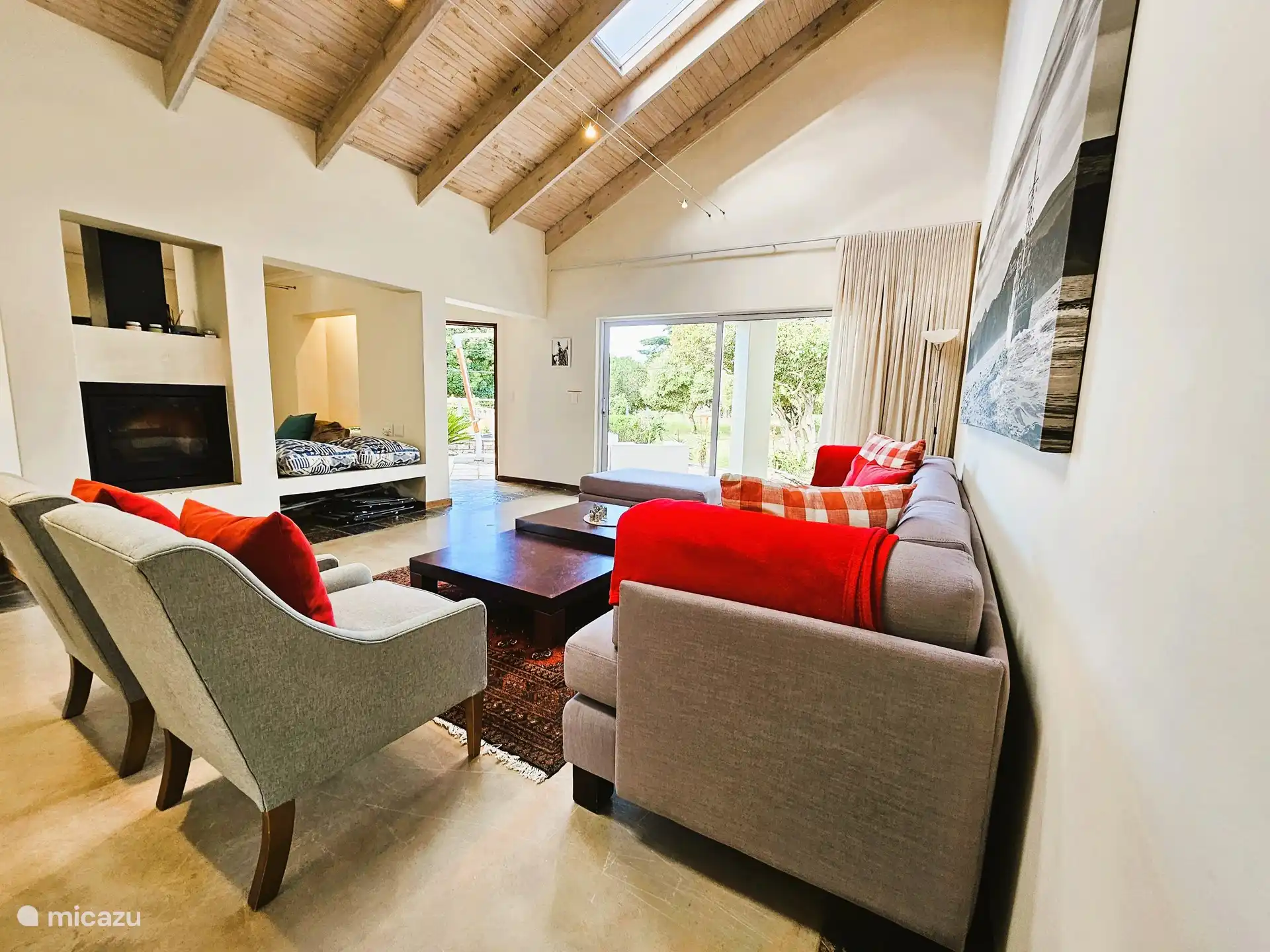 Open plan on the ground floor. Two different lounges with sofas, opens to the outdoor pool and entertainment area.