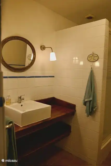 The bathroom with shower and toilet.