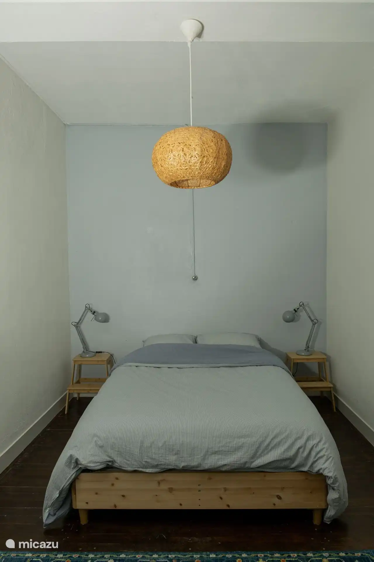 The comfortable double bed in the bedroom.