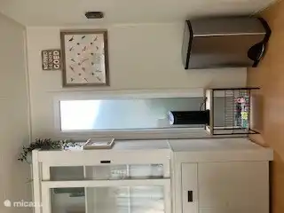 The waste bin can be easily removed with a foot pedal and closes by itself. And the cooling air conditioning for the hot days. In the top drawers of the china cabinet, you'll find extension cords and plugs. Also a first aid bag for the small accidents.