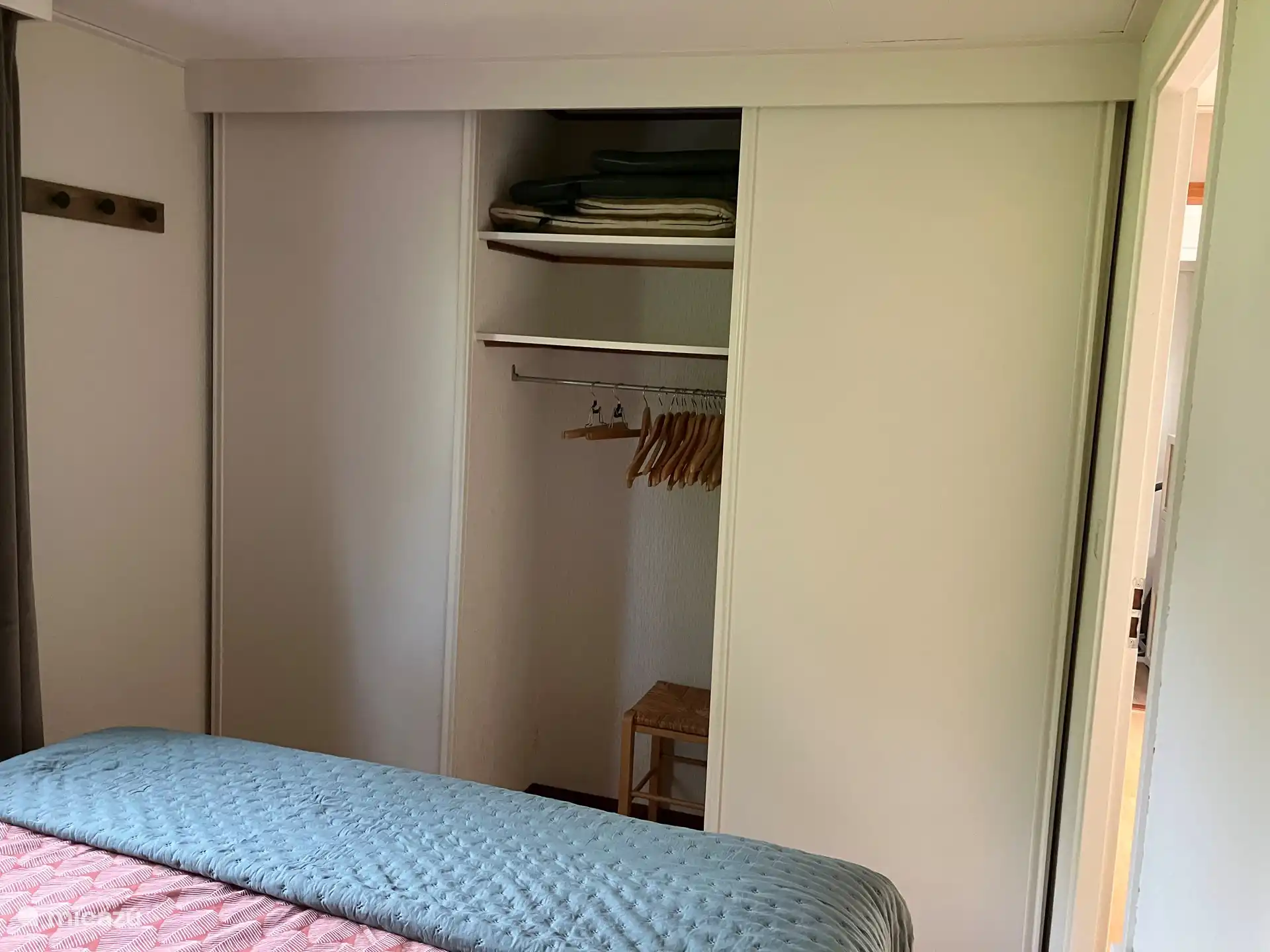 A large wardrobe with sliding doors offers space for a lot of clothes. The right side of the closet is closed for private items. You will also find the outdoor pillows and extra sleeping gear on the top shelf.
