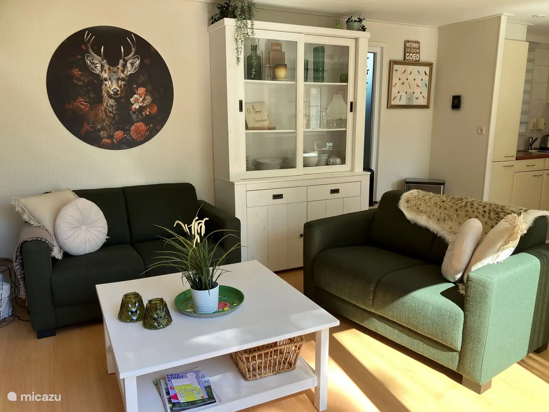 The living room with 2 double sofas, coffee table, closet, TV, atmospheric lighting, sliding door to the terrace and views of the forest.