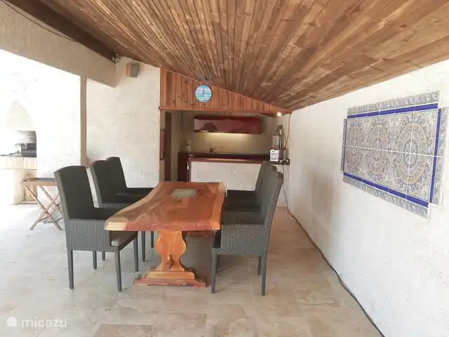 Outdoor kitchen and BBQ in pool house.