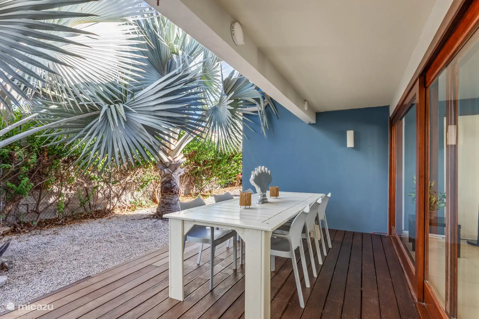 Shaded back porch with dinner table.
