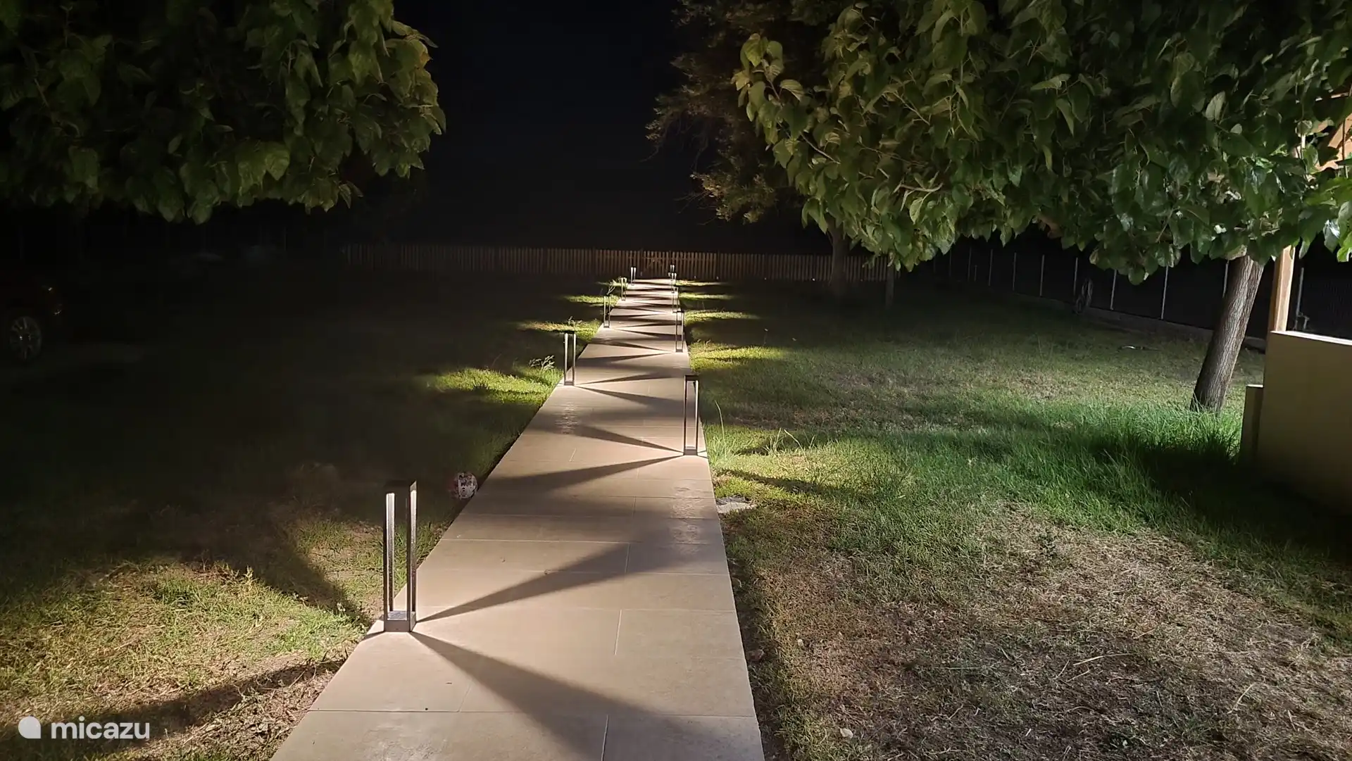 Illuminated corridor leading to the (almost) private beach