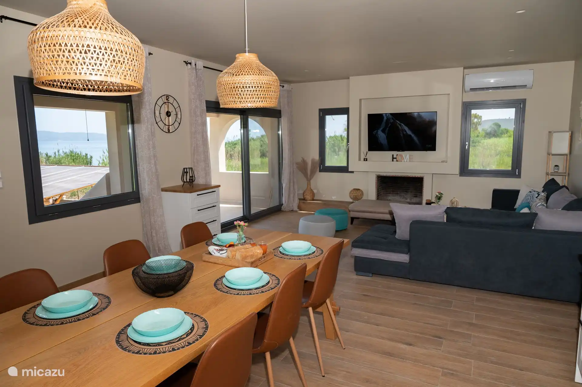 Living room with 55-inch smart LED TV and wonderful garden and sea view