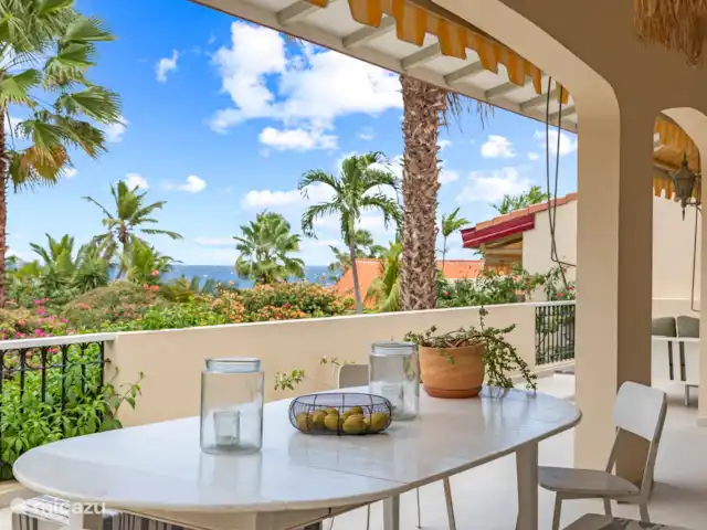 Royal Beach House, Royal Palm resort huren in Curaçao, Curacao-Midden, Piscadera - villa Dinergedeelte in de schaduw met uitzicht over de Caribische zee