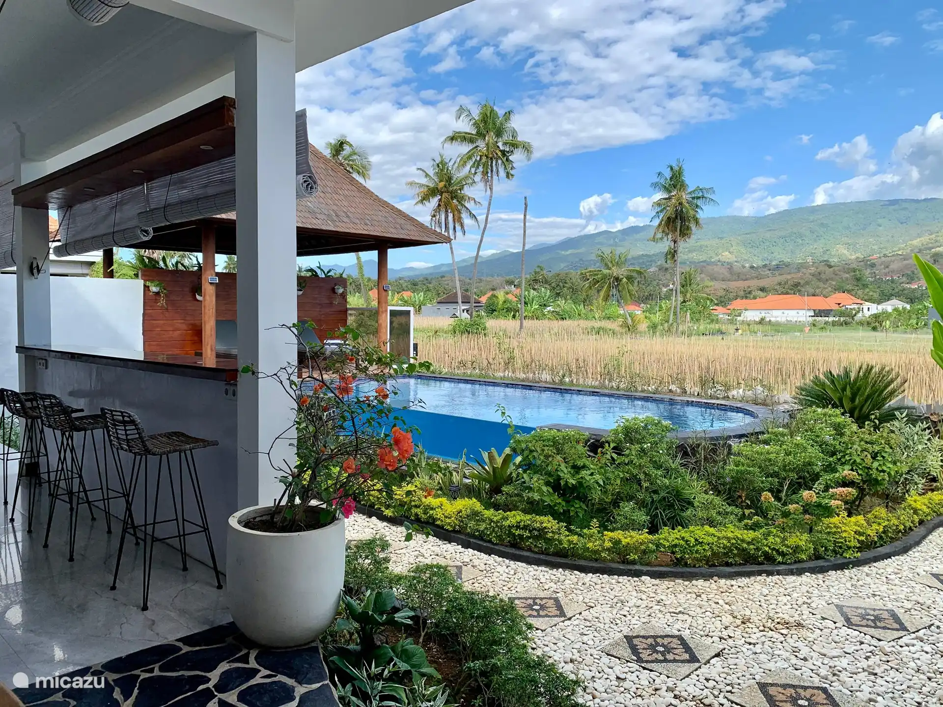 At the bar by the outdoor kitchen overlooking both the swimming pool, the garden the beautiful and quiet surroundings