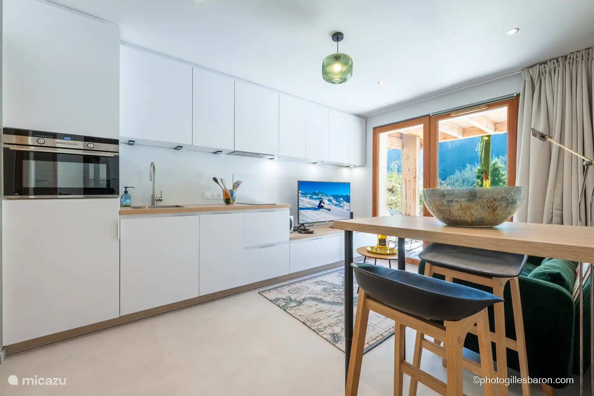 Kitchenette with multifunctional oven and induction hob.