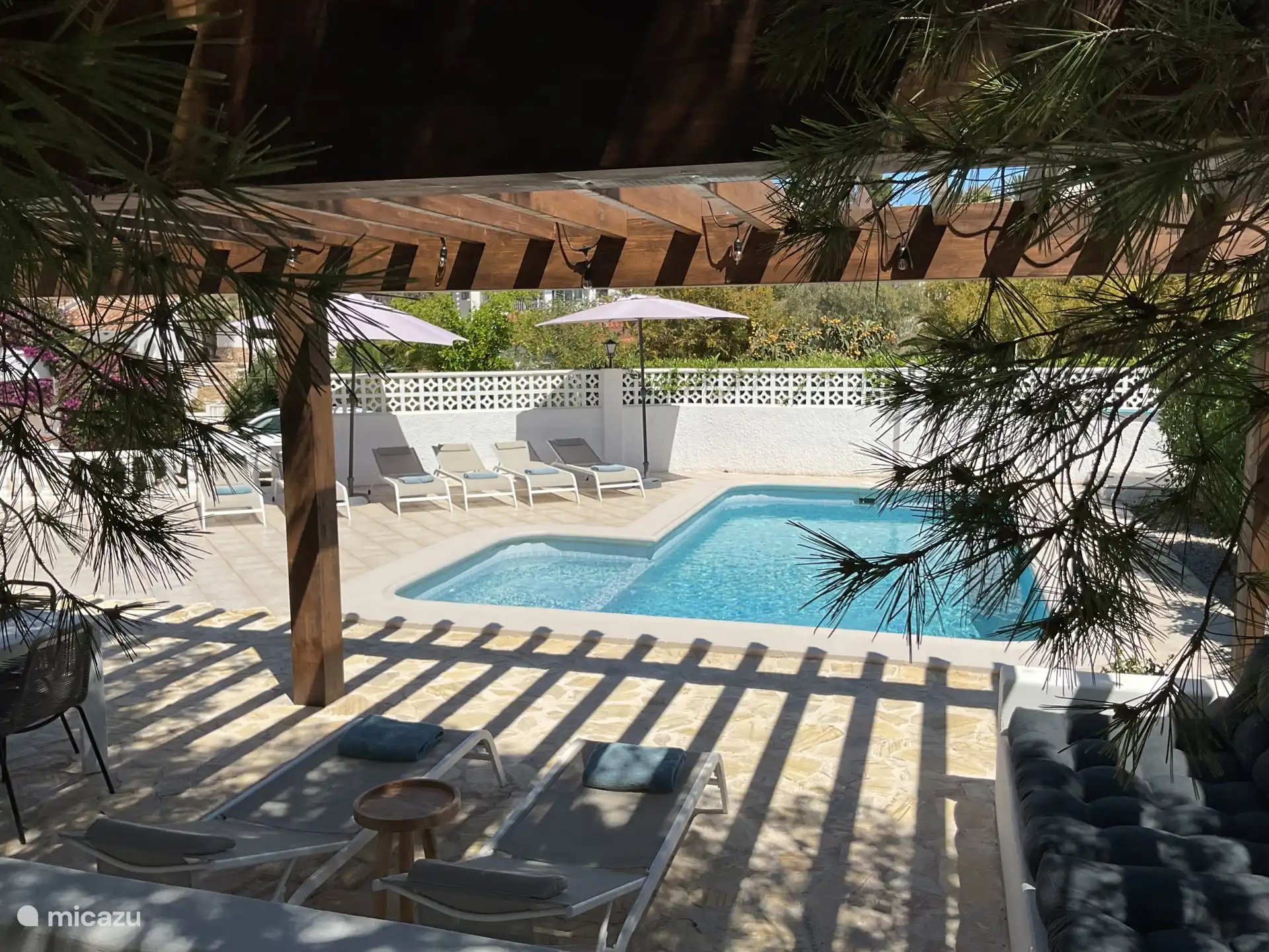 Pergola besides the pool