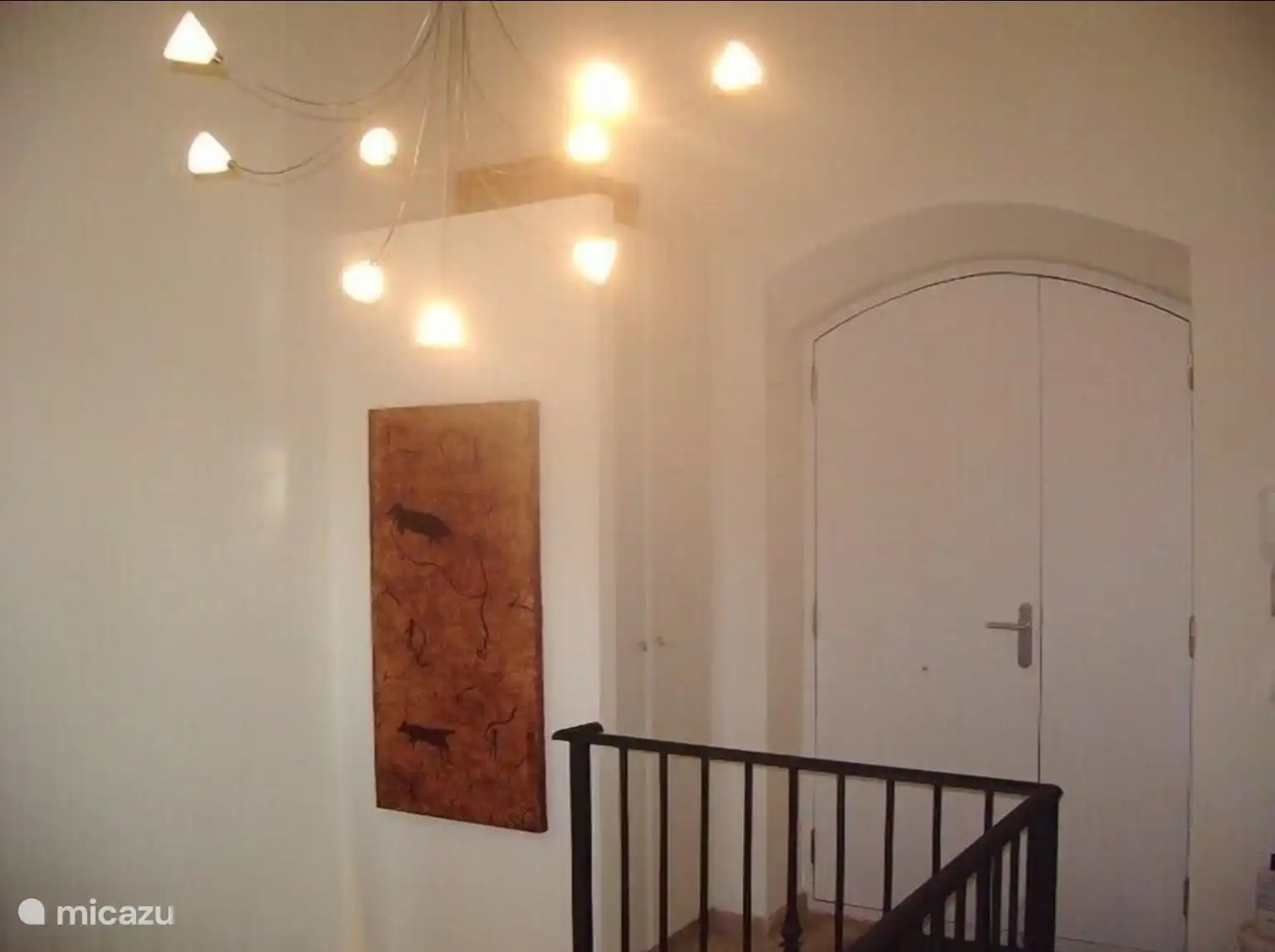 the entrance with two bedrooms upstairs and the two bathrooms and the stairs down