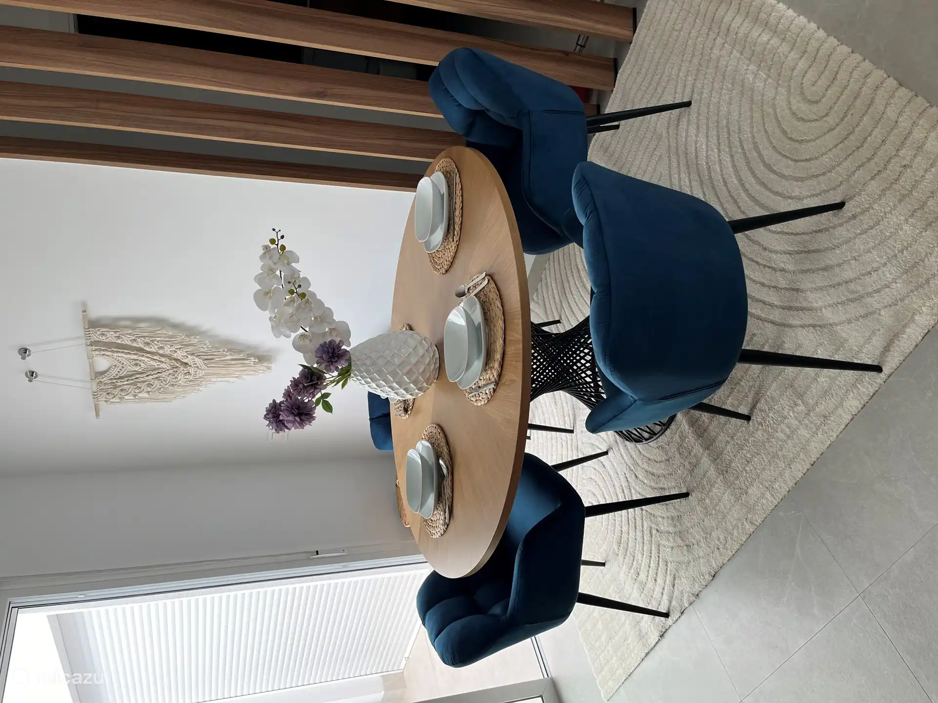 The dining table with nice soft fabric chairs.