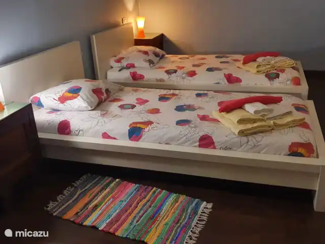 Villa al Plin huren in Italië, Piëmont, Vesime - villa Eén van de slaapkamers met losse bedden, die eenvoudig tegen elkaar te schuiven zijn. Deze kamer heeft direct toegang tot de badkamer met bad en tot de overloop. Er is een ladekast en een kledingrek.